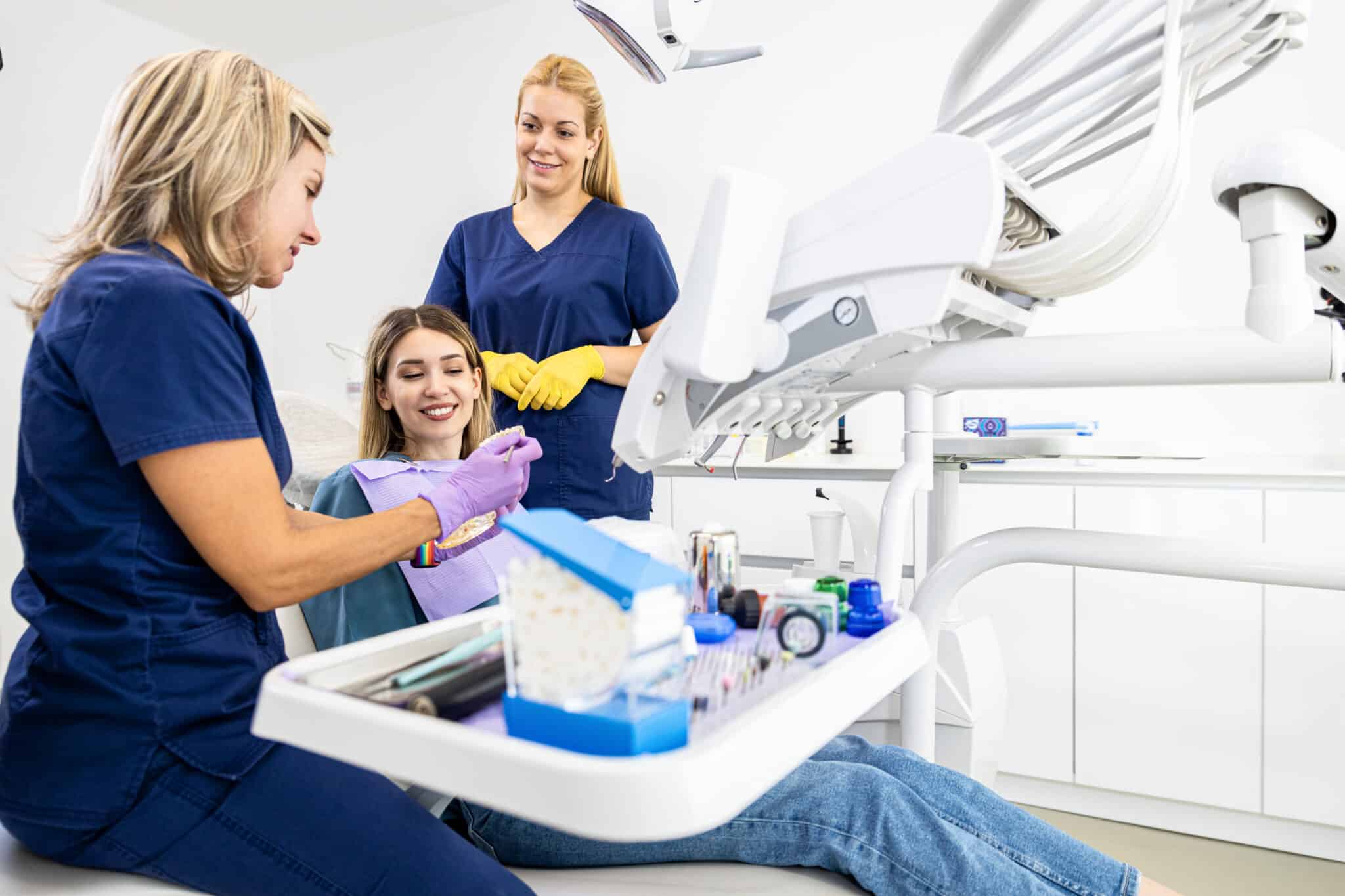 dental, dental office, dentist office near me, dentistry - Female dentist with assistant working in dental clinic examining